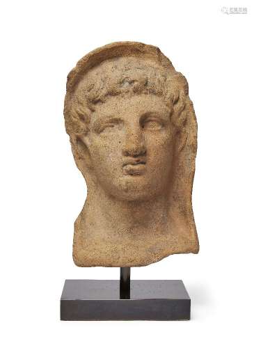 An Etruscan terracotta votive head of a young man, circa 3rd-2nd Century B.C., of hollow form,