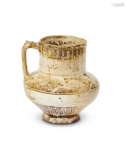 A small intact Kashan lustre-glazed jug with inscriptions, Iran, late 12th century, on a short