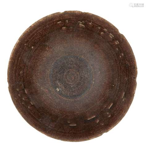 A manganese glazed bowl, Iran, late 12th-early 13th century, of conical form on a short foot, the
