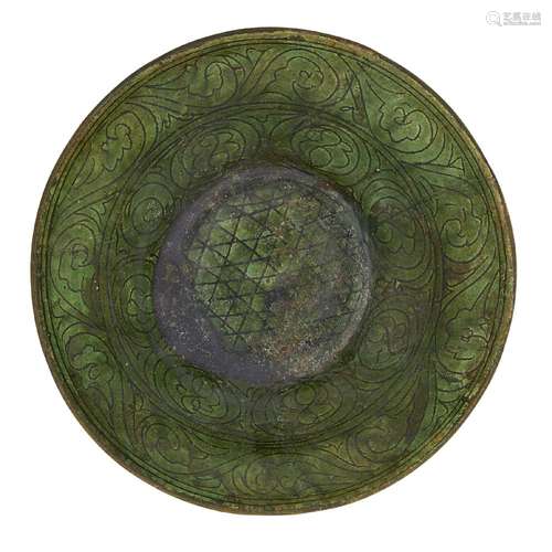 A restored Garrus-ware green-glazed bowl, Iran, 12th century, with flared sides and flat base, the