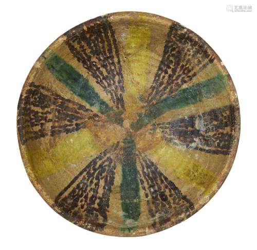 A Nishapur pottery bowl, Iran, 10th century, underglaze painted in yellow, black and green, 20.