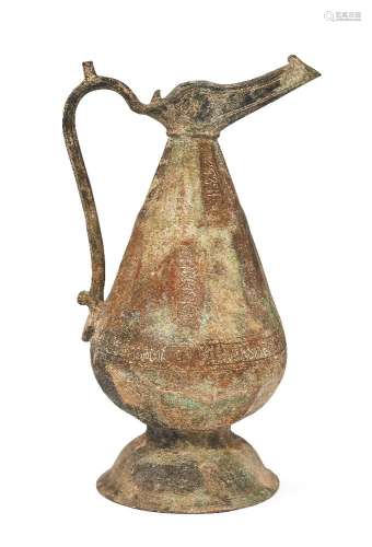 A Khorasan faceted silver inlaid bronze ewer, Iran, 12th century, of globular form on a domed