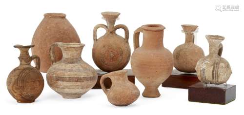 A group of pottery vessels including a Cypro-Mycenaean vessel with squat globular body and loop