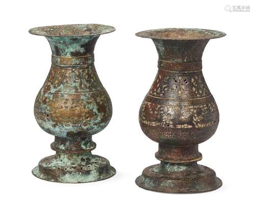 A pair of copper and silver inlaid openwork large vases, Iran, 14th century, each on a raised