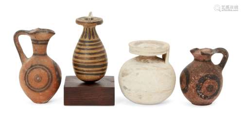 Four pottery vessels, including a Corinthian spherical aryballos with worn lotus decoration, 6.