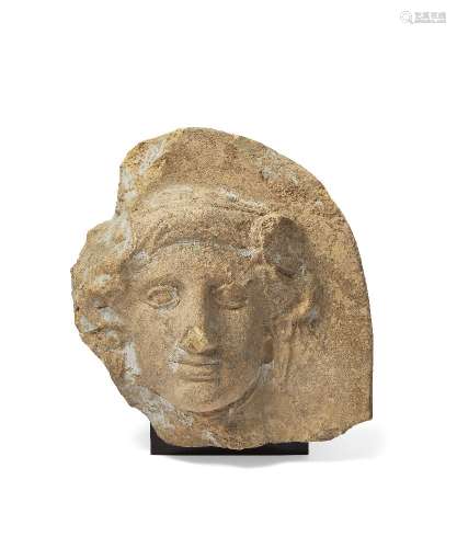 A Greek terracotta antefix with the head of Io, Taranto, circa 4th Century B.C., the nymph