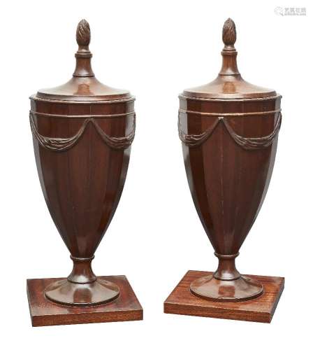 A pair of mahogany urn form knife boxes, in the George III style, mid/late 20th century, the lids