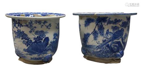 A near pair of Japanese blue and white jardinières, 20th century, decorated with landscapes of