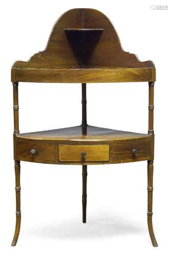 A Victorian mahogany corner washstand, the curved top shelf with shaped splash back, over