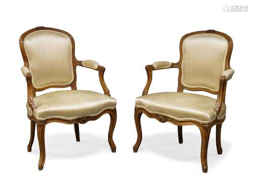 A pair of Louis XV beech fauteuils by Jean Boucault, mid 18th Century, one chair stamped 'Boucault',