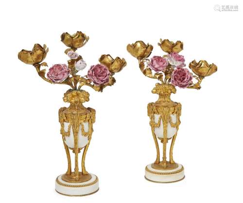 A pair of French ormolu and white marble three branch candelabra, early/ mid 20th century, the bases