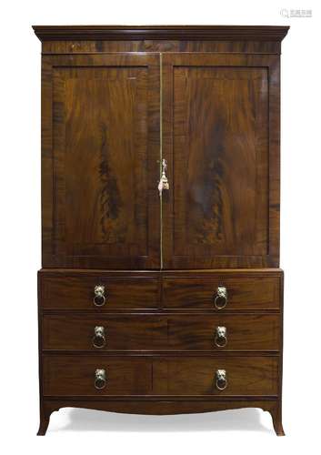 A Victorian mahogany linen press, the moulded cornice above two crossbanded doors, enclosing five