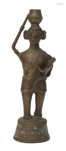 A Nigerian bronze maternity figure, 20th century, modelled standing cradling a child and carrying