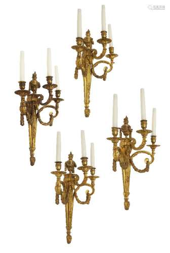 A set of four Louis XVI style three branch wall lights, 20th century, each with urn form finial to a