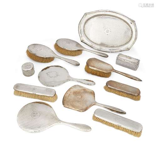 An eight piece silver-backed vanity set, comprising six brushes and two hand mirrors complete with