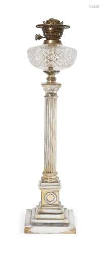 A Victorian silver-plated oil lamp, with brass burner fittings above a glass reservoir, the column