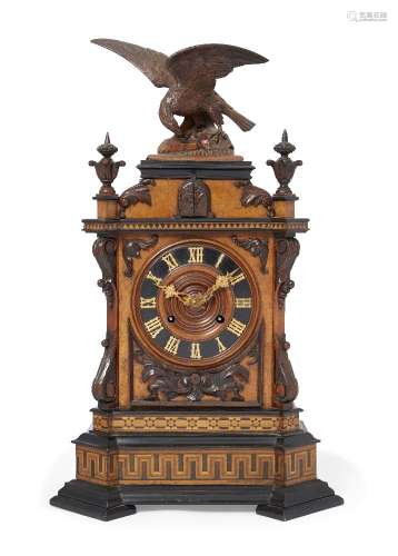 A Black Forest walnut, parquetry and ebonised wood cuckoo clock, 19th century, the top mounted