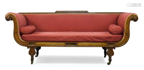 A Regency mahogany sofa, the top rail with raised gadrooning, having carved scrolling arms,