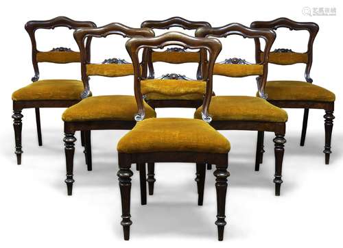 A set of six Victorian mahogany dining chairs, the shaped open backs with carved and padded