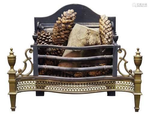 A George III style brass and iron serpentine fire grate, with urn finials, the front with shaped