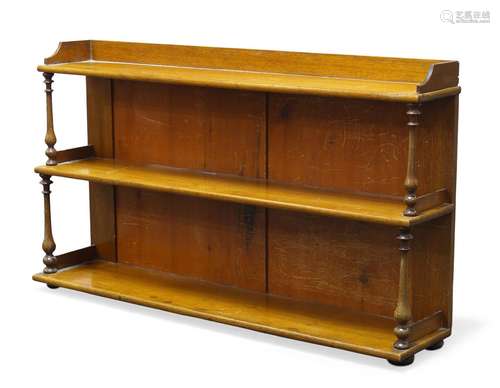 A set of Victorian shelves, having three graduated tiers, with turned baluster supports, raised on