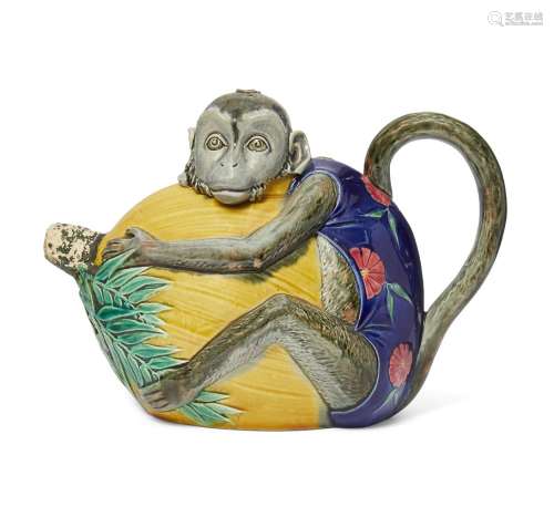 A Minton majolica tea pot and cover, 19th century, in the form of a monkey clasping a fruit,