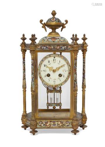 A French champlevé and brass mantel clock, 20th century, mounted with an urn finial, the glazed