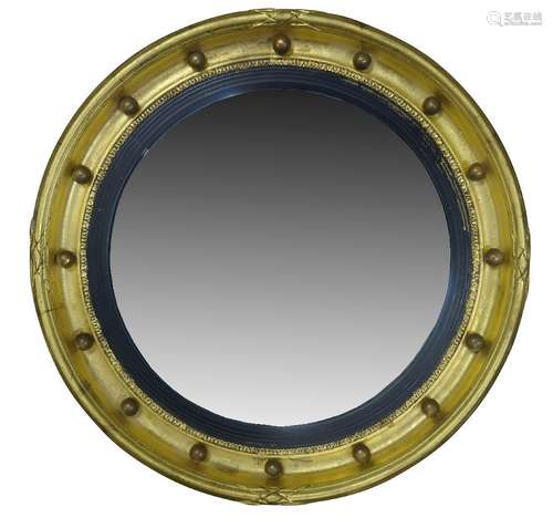 A Regency style gilt framed circular wall mirror, 20th Century, the convex plate set within ebonised