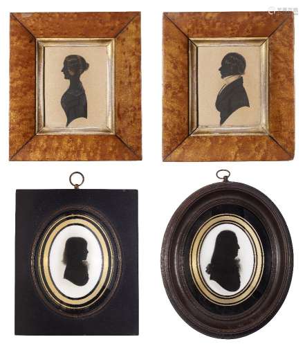 A pair of silhouette portraits of a husband and wife, 19th century, in matching maple veneered