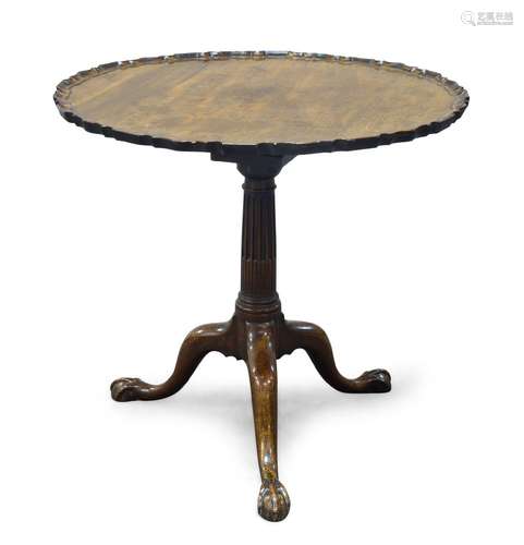 A George III mahogany tilt top occasional table, the circular pie crust top above tapering stop