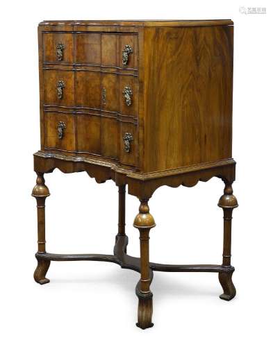 A William and Mary style walnut cabinet on stand, early 20th Century, with recessed serpentine