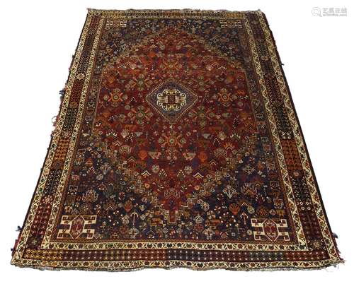 A Qashqai rug, mid/late 20th Century, with medallion in deep red field with step edged spandrels,