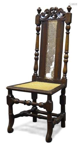 A stained beech and caned highback chair, 17th Century and later, the top rail with carved and