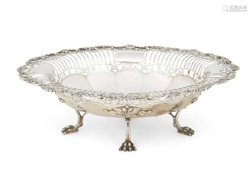 A pierced silver dish, Sheffield, c.1913, Mappin & Webb, raised on four lion paw feet, the perimeter