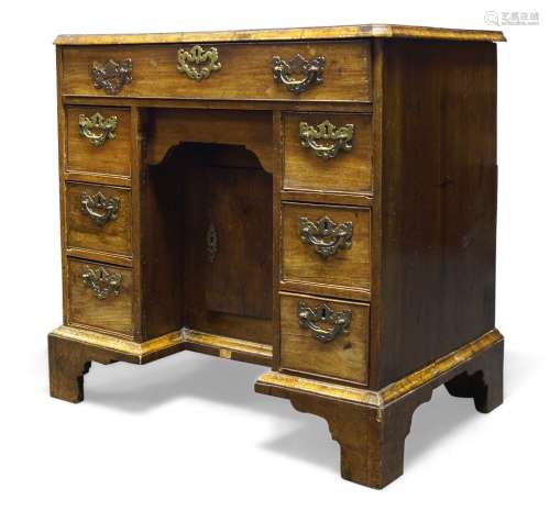 A George I walnut kneehole desk, the rectangular top above frieze drawer and blind frieze drawer