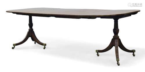 A George III twin pedestal dining table, the rounded rectangular top with two additional leaves,