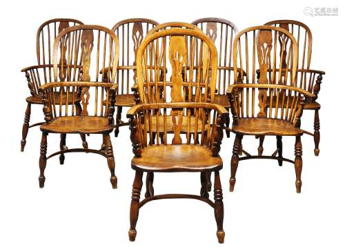 A matched set of ash and elm Windsor armchairs, 19th Century and later, the hooped backs, with