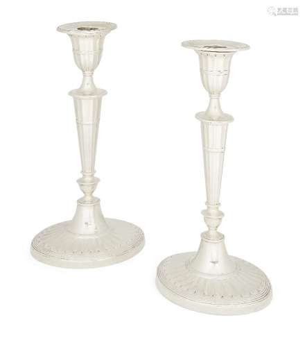 A pair of Victorian silver candlesticks, London, c.1890, William Hutton & Sons., each raised on a