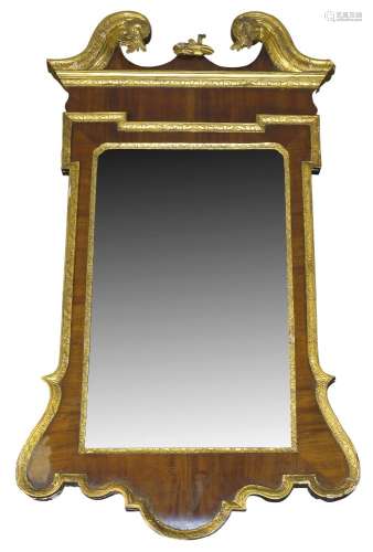 A George II style mahogany and parcel gilt wall mirror,19th Century, the swan neck pediment with