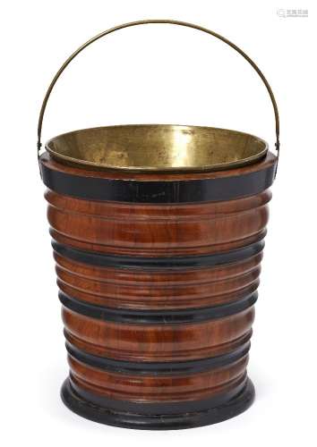 A Dutch walnut and ebonised wood peat bucket, 19th century, with a brass liner, 32cm highPlease