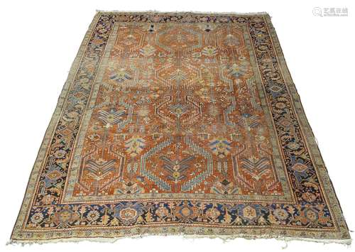 A Heriz carpet, early 20th Century, the deep red field with symmetrical all over design enclosed