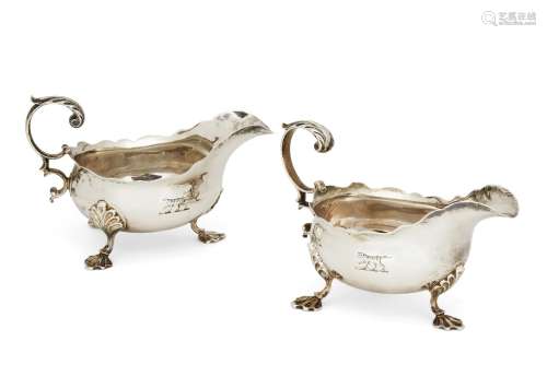 A pair of George III silver sauce boats, London c.1762, Fuller White, each raised on three shell-