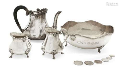 A three-piece Indian silver tea set, comprising a tea pot, milk jug and sugar pot, each raised on