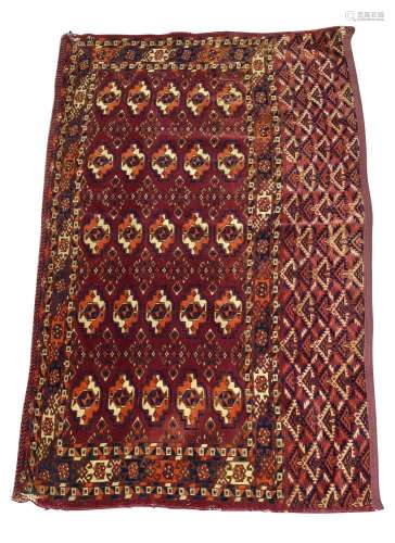 A Tekke Ensi, mid/late 20th Century, with five rows of guls in a claret field, 130cm x 70cm,