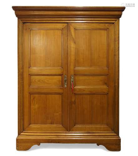 A French provincial fruitwood armoire, 19th Century, the moulded top above two panelled cupboard