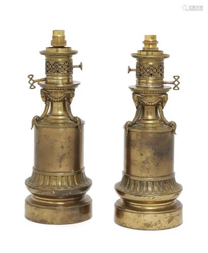 A pair of Victorian brass sinumbra lamps, early/mid 19th century, each with pierced Gothic tracery