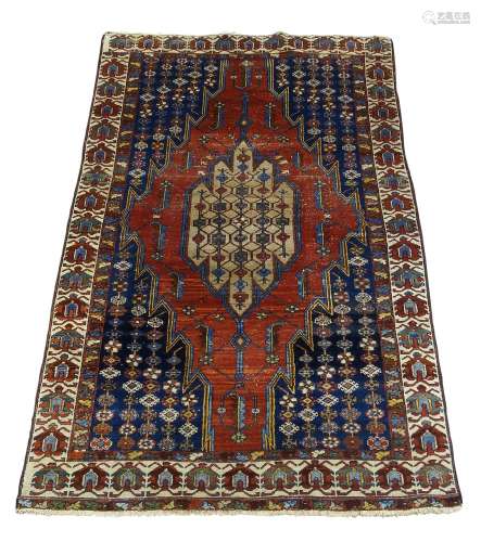 A Hamadan rug, early 20th Century, with pole medallion in red field, with ivory main border, 197cm x