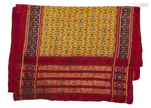 A large Ikat design silk spread, 20th century, with stylised motifs on a yellow ground with red