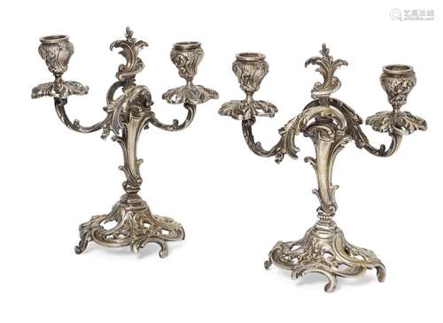 A pair of Continental silvered brass candelabra, late 19th/early 20th century, the bases pierced