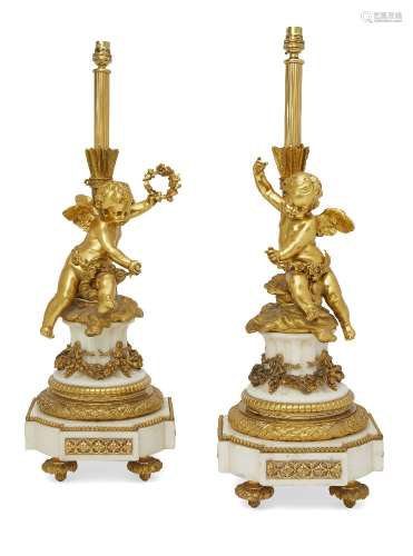 A pair of gilt bronze and white marble candelabra bases, in the Louis XVI style, 19th century, later